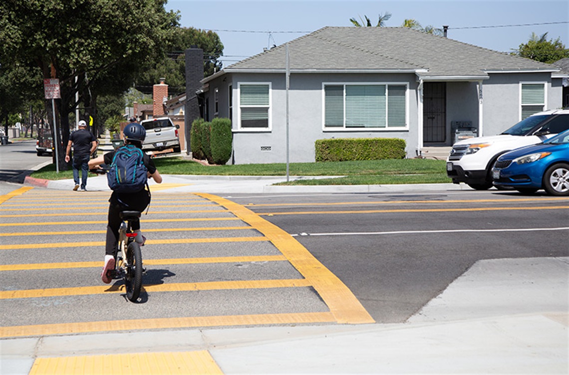 Child on bike at crosswalk