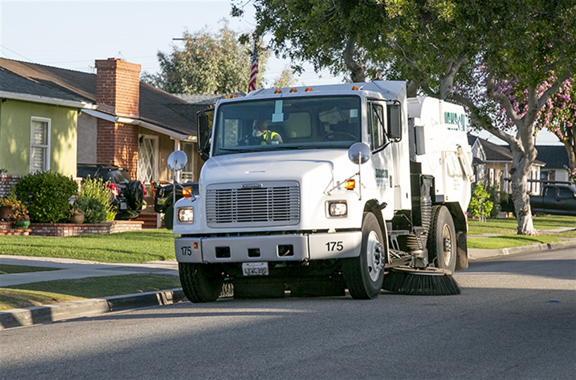 Street sweeper coming down residential street